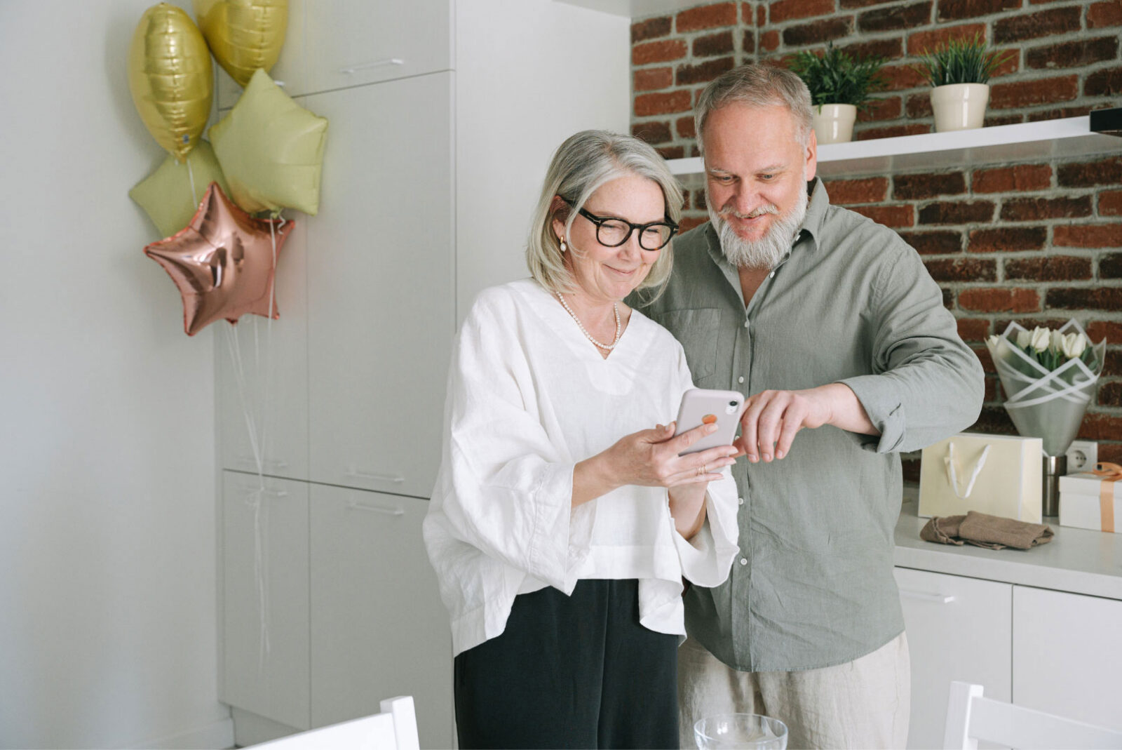 Couple enjoying a moment together, looking at a phone.
